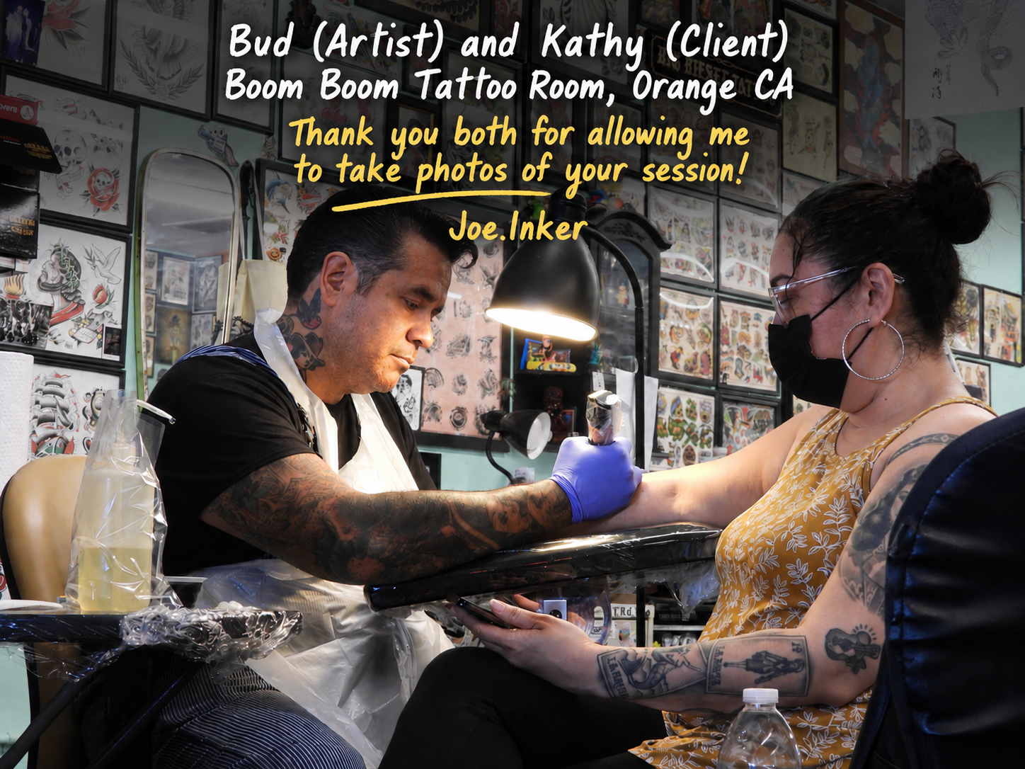 Tattoo artist working on a client during a session inside a tattoo shop with flash art on the walls